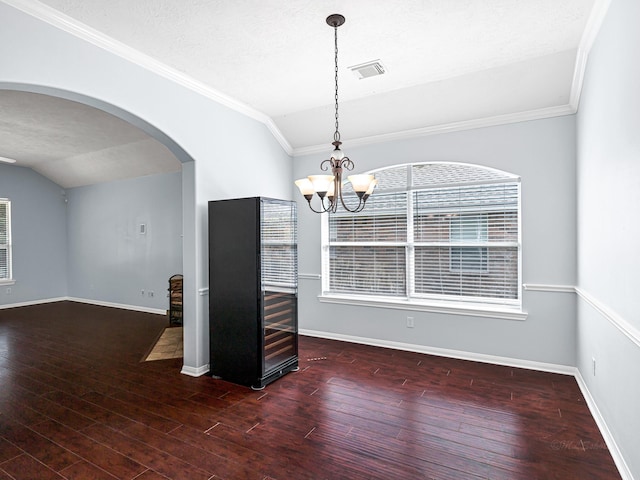 25203 Auburn Terrace Dr, Spring, TX 77389 - empty room with arched walkways, a chandelier, crown molding, wood finished floors, and baseboards