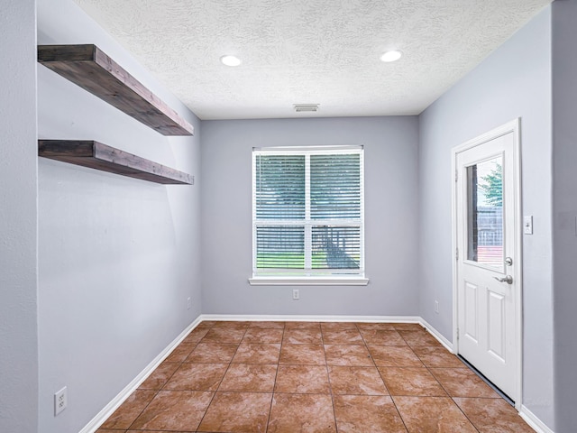 25203 Auburn Terrace Dr, Spring, TX 77389 - tiled foyer with a textured ceiling, baseboards, and recessed lighting