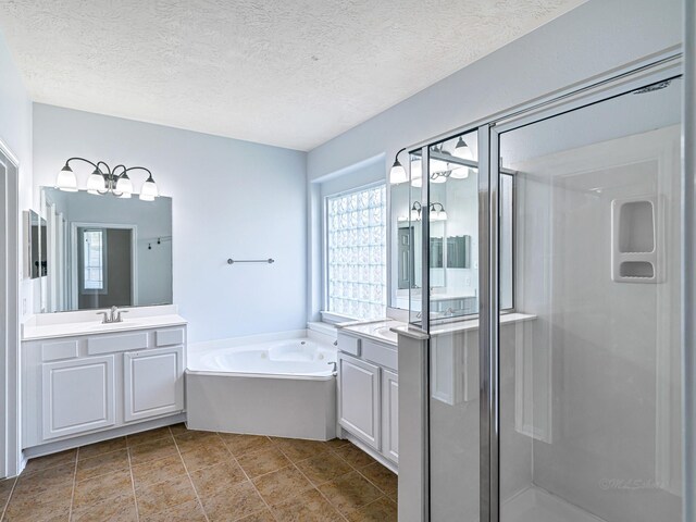 25203 Auburn Terrace Dr, Spring, TX 77389 - bathroom featuring healthy amount of natural light, a shower stall, vanity, a bath, and a textured ceiling