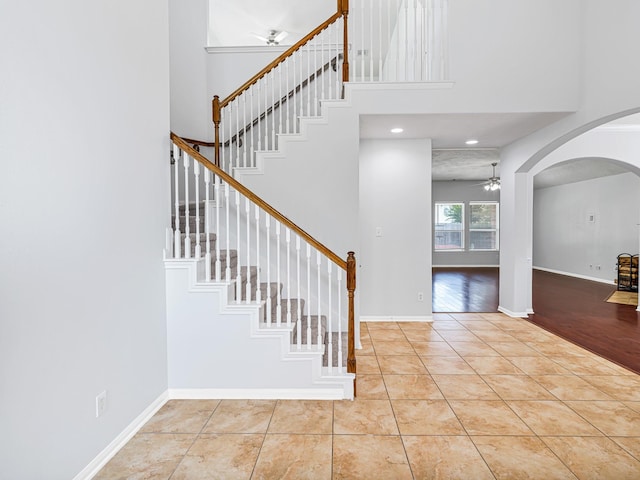 25203 Auburn Terrace Dr, Spring, TX 77389 - entryway with a ceiling fan, arched walkways, tile patterned flooring, a high ceiling, and stairs