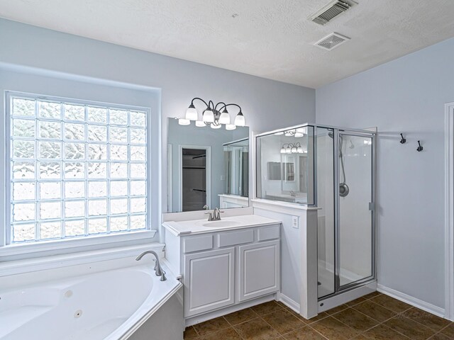 25203 Auburn Terrace Dr, Spring, TX 77389 - full bathroom with healthy amount of natural light, a stall shower, vanity, a whirlpool tub, and a textured ceiling