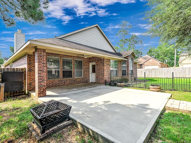 25203 Auburn Terrace Dr, Spring, TX 77389 - rear view of property featuring brick siding, an outdoor fire pit, a ceiling fan, a patio area, and a chimney