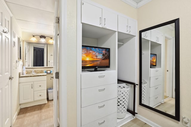 6102 Seawall Blvd Unit 260, Galveston, TX 77551 - bathroom featuring ornamental molding and vanity