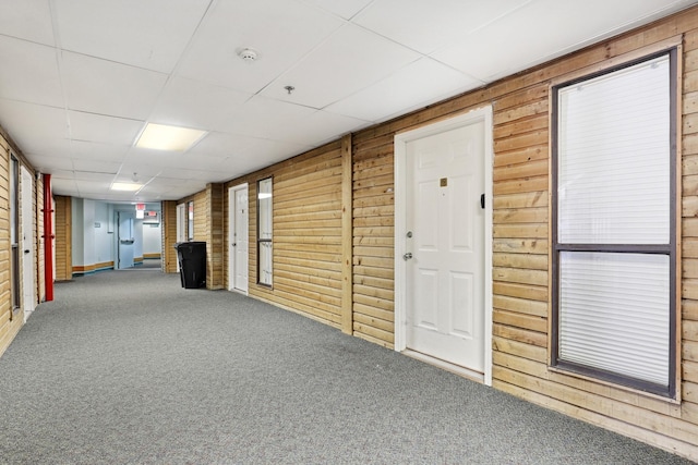 6102 Seawall Blvd Unit 260, Galveston, TX 77551 - hall with wooden walls and carpet