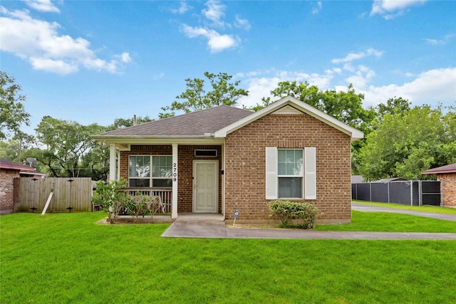 2709 Virginia St, La Marque, TX 77568 - view of front facade with a gate, brick siding, and a shingled roof