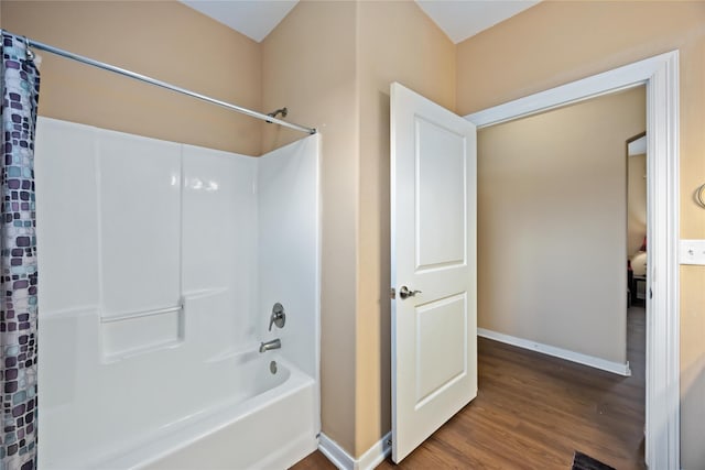 2709 Virginia St, La Marque, TX 77568 - bathroom featuring wood finished floors, baseboards, and shower / bath combo with shower curtain