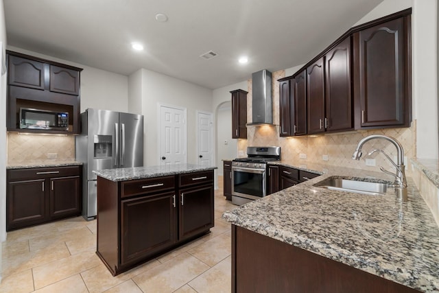 9131 Durango Point Ln, Houston, TX 77070 - kitchen featuring stainless steel appliances, wall chimney exhaust hood, a sink, light stone counters, and dark brown cabinets
