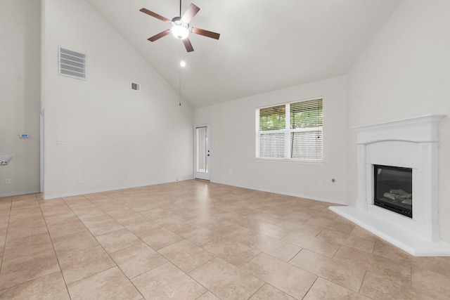 9131 Durango Point Ln, Houston, TX 77070 - unfurnished living room featuring a ceiling fan, a glass covered fireplace, high vaulted ceiling, and light tile patterned floors