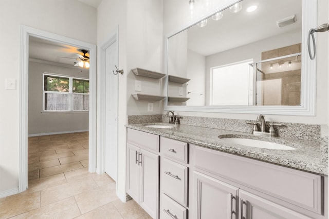 9131 Durango Point Ln, Houston, TX 77070 - full bath with double vanity, a stall shower, tile patterned floors, a ceiling fan, and baseboards