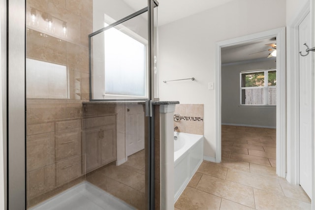 9131 Durango Point Ln, Houston, TX 77070 - bathroom with a ceiling fan, a garden tub, tile patterned flooring, crown molding, and a stall shower