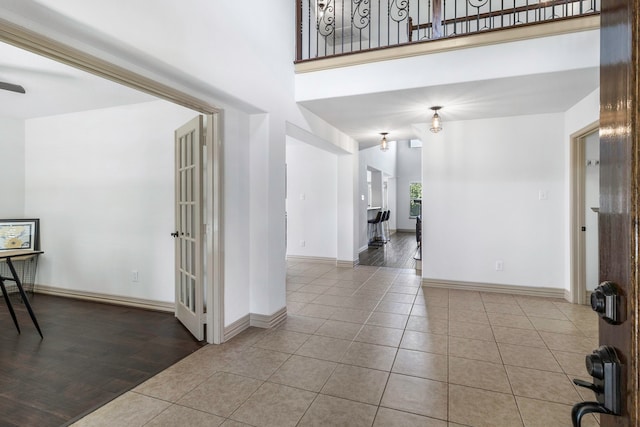 6907 Autumn Rain Ln, Spring, TX 77379 - foyer entrance featuring tile patterned floors, baseboards, and a high ceiling