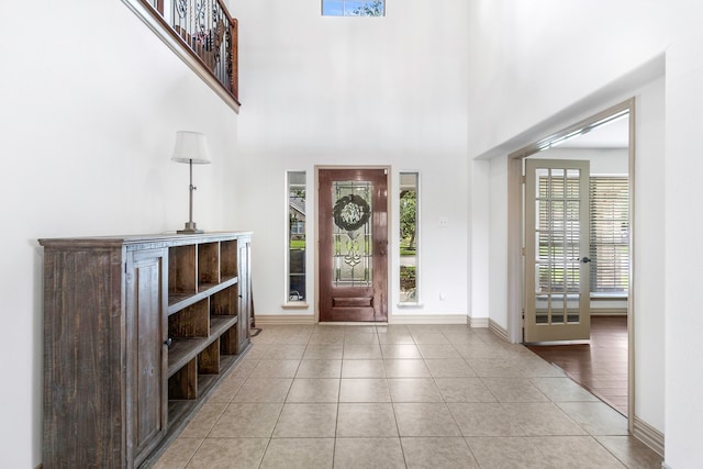 6907 Autumn Rain Ln, Spring, TX 77379 - entryway featuring tile patterned flooring, baseboards, a high ceiling, and french doors