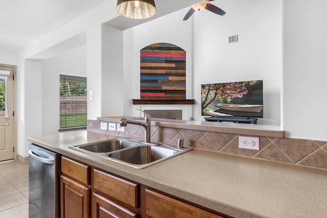 6907 Autumn Rain Ln, Spring, TX 77379 - kitchen with dishwasher, a sink, brown cabinetry, light tile patterned flooring, and a ceiling fan