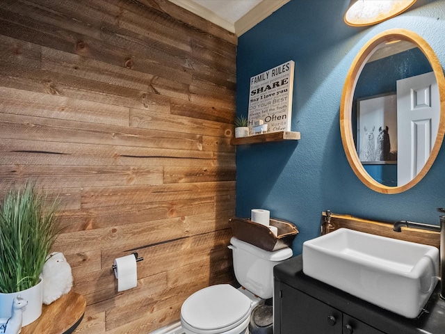 6907 Autumn Rain Ln, Spring, TX 77379 - bathroom featuring toilet, a textured wall, wood walls, and vanity