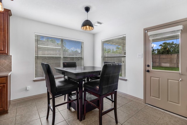6907 Autumn Rain Ln, Spring, TX 77379 - dining area featuring healthy amount of natural light, light tile patterned floors, and baseboards