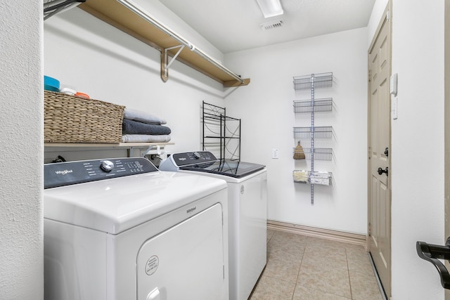 6907 Autumn Rain Ln, Spring, TX 77379 - laundry area with independent washer and dryer, light tile patterned floors, and baseboards