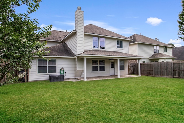 6907 Autumn Rain Ln, Spring, TX 77379 - rear view of house with a patio, a ceiling fan, a shingled roof, and a chimney