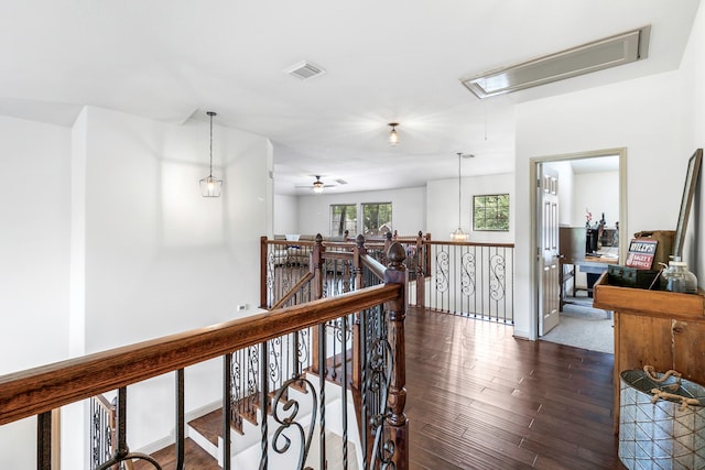 6907 Autumn Rain Ln, Spring, TX 77379 - hall featuring attic access, dark wood-type flooring, and an upstairs landing