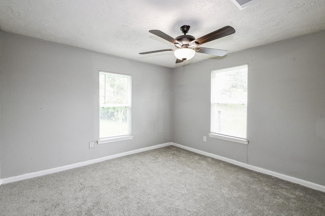 312 Hemphill St, Texas City, TX 77591 - carpeted empty room featuring healthy amount of natural light, a ceiling fan, a textured ceiling, and baseboards