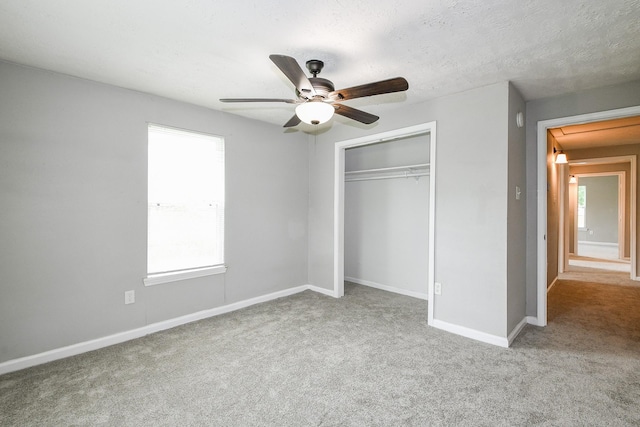 312 Hemphill St, Texas City, TX 77591 - unfurnished bedroom featuring carpet flooring, a closet, baseboards, and a ceiling fan