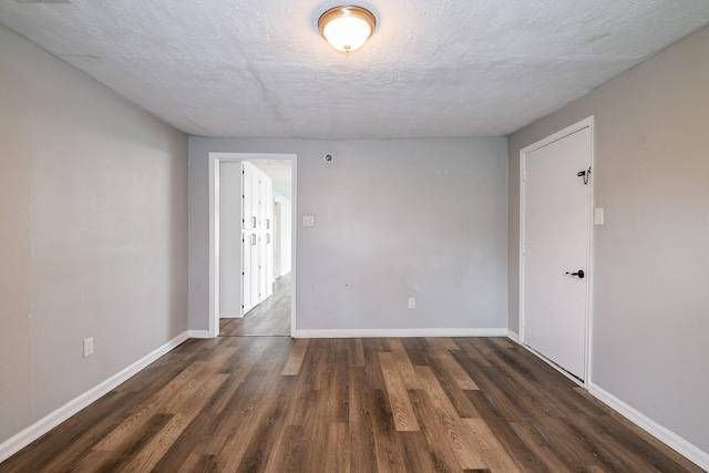 312 Hemphill St, Texas City, TX 77591 - spare room with dark wood finished floors, a textured ceiling, and baseboards
