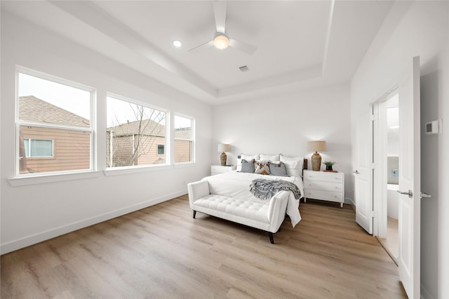 5238 Larkin St, Houston, TX 77007 - bedroom featuring a tray ceiling, light wood-style floors, baseboards, and ceiling fan