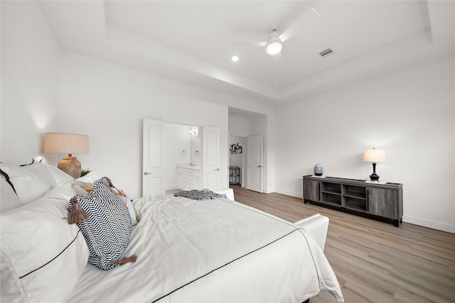 5238 Larkin St, Houston, TX 77007 - bedroom with a raised ceiling, light wood finished floors, baseboards, and a ceiling fan