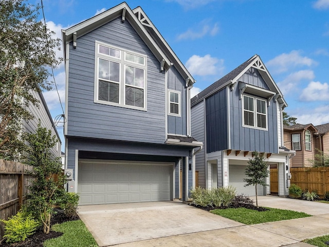 5238 Larkin St, Houston, TX 77007 - view of front facade with a garage, concrete driveway, and board and batten siding