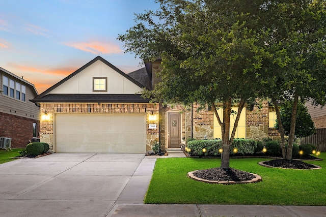 3266 Karleigh Way, Richmond, TX 77406 - view of front of house with driveway, a lawn, an attached garage, brick siding, and stone siding