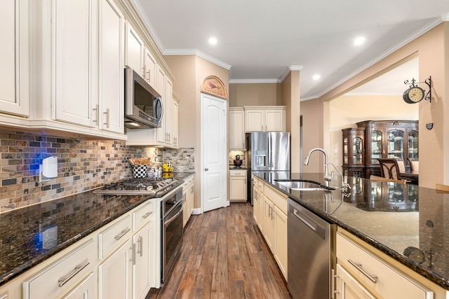 3266 Karleigh Way, Richmond, TX 77406 - kitchen featuring stainless steel appliances, a sink, dark wood finished floors, crown molding, and dark stone countertops