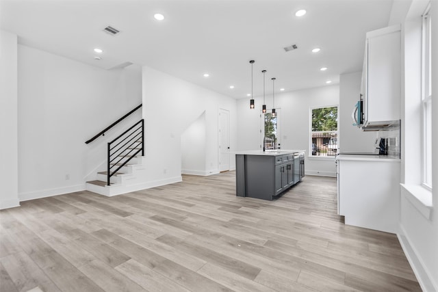 2475 Carmel St A/B, Unit A/B Houston, TX 77091 - kitchen with light wood-style floors, a kitchen island, light countertops, gray cabinets, and recessed lighting