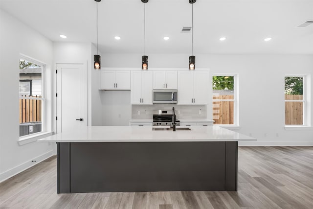 2475 Carmel St A/B, Unit A/B Houston, TX 77091 - kitchen featuring appliances with stainless steel finishes, a sink, light countertops, white cabinets, and recessed lighting