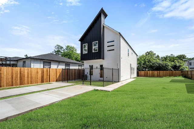 2475 Carmel St A/B, Unit A/B Houston, TX 77091 - back of property with board and batten siding and a patio