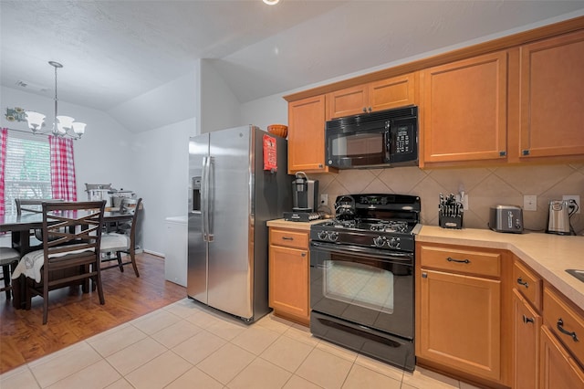 18019 Iris Edge Way, Cypress, TX 77429 - kitchen with black appliances, lofted ceiling, light countertops, tasteful backsplash, and a chandelier