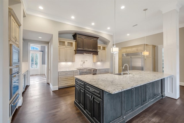 1518 Hillendahl Blvd, Houston, TX 77055 - kitchen featuring built in appliances, a sink, a warming drawer, cream cabinetry, and light stone countertops