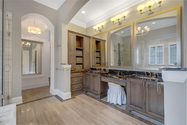 1518 Hillendahl Blvd, Houston, TX 77055 - bathroom with double vanity, a shower stall, crown molding, a chandelier, and wood finished floors