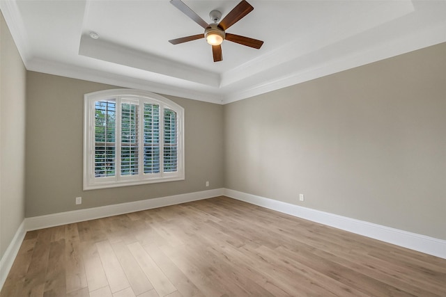 1518 Hillendahl Blvd, Houston, TX 77055 - spare room with a raised ceiling, crown molding, light wood-style flooring, ceiling fan, and baseboards