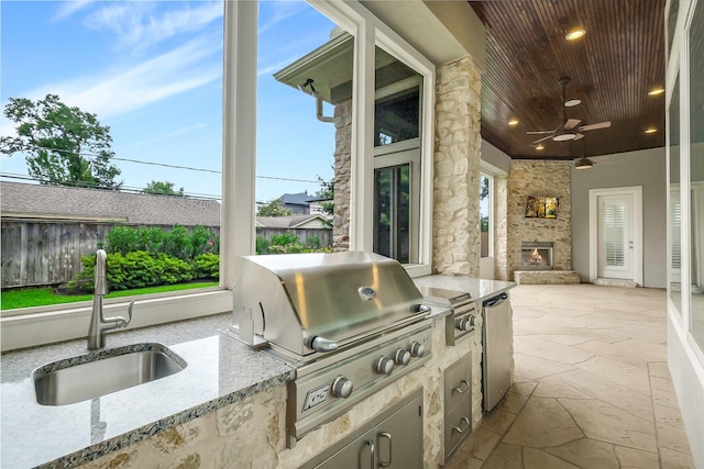 1518 Hillendahl Blvd, Houston, TX 77055 - view of patio / terrace with an outdoor stone fireplace, exterior kitchen, and a ceiling fan