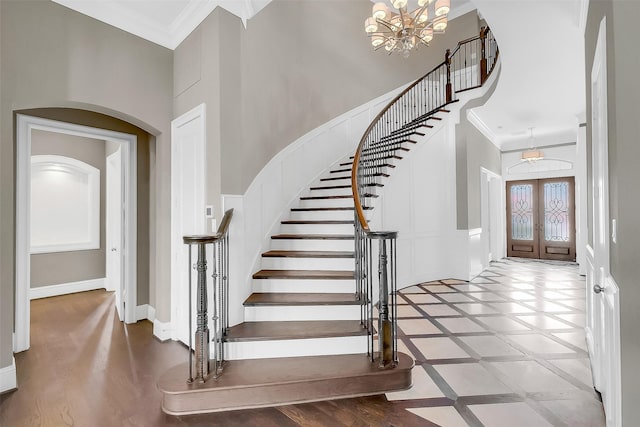 1518 Hillendahl Blvd, Houston, TX 77055 - foyer entrance featuring a towering ceiling, ornamental molding, stairs, a chandelier, and arched walkways
