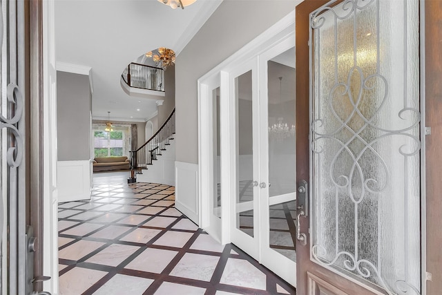 1518 Hillendahl Blvd, Houston, TX 77055 - foyer entrance featuring inlaid floor details, crown molding, a wainscoted wall, stairs, and french doors