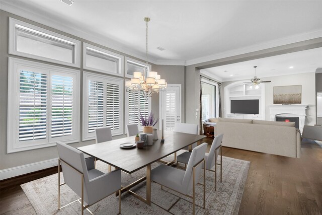 1518 Hillendahl Blvd, Houston, TX 77055 - dining area featuring ceiling fan, dark wood finished floors, ornamental molding, a chandelier, and a warm lit fireplace