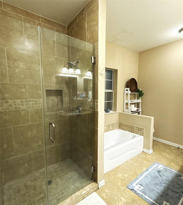 40 Dartmoor Ct, Coldspring, TX 77331 - full bathroom featuring a garden tub, a shower stall, tile patterned flooring, and baseboards