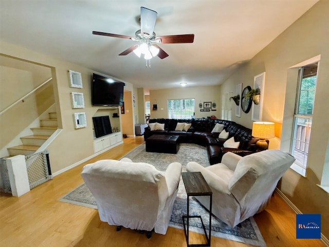 40 Dartmoor Ct, Coldspring, TX 77331 - living area with a fireplace, light wood-type flooring, ceiling fan, stairs, and baseboards