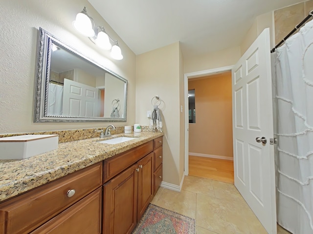 40 Dartmoor Ct, Coldspring, TX 77331 - full bath with vanity, tile patterned floors, and baseboards