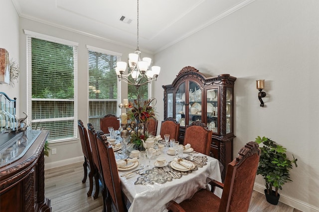 18786 Monetta Dr, New Caney, TX 77357 - dining area featuring a chandelier, wood finished floors, baseboards, and ornamental molding