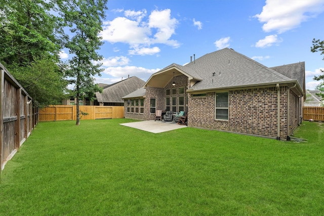 18786 Monetta Dr, New Caney, TX 77357 - back of property featuring roof with shingles, a patio area, and brick siding