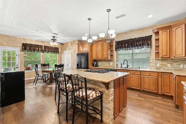 3602 Blue Lake Dr, Spring, TX 77388 - kitchen with open shelves, black refrigerator with ice dispenser, light wood-style floors, ceiling fan, and a sink