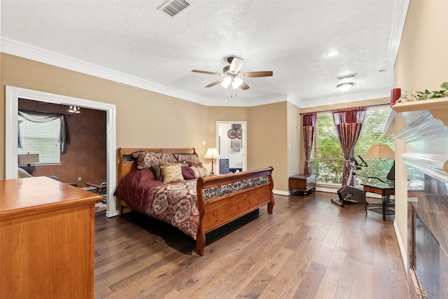 3602 Blue Lake Dr, Spring, TX 77388 - bedroom featuring wood-type flooring, a textured ceiling, ornamental molding, and baseboards