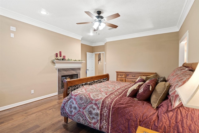 3602 Blue Lake Dr, Spring, TX 77388 - bedroom featuring wood finished floors, baseboards, ornamental molding, a premium fireplace, and ceiling fan