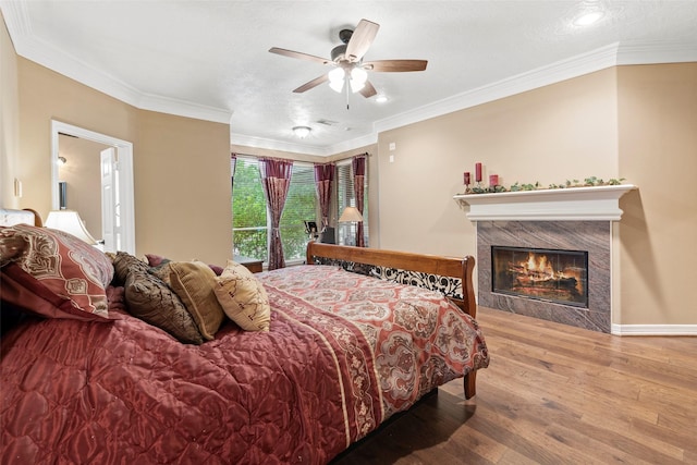 3602 Blue Lake Dr, Spring, TX 77388 - bedroom with hardwood / wood-style flooring, crown molding, a fireplace, baseboards, and ceiling fan